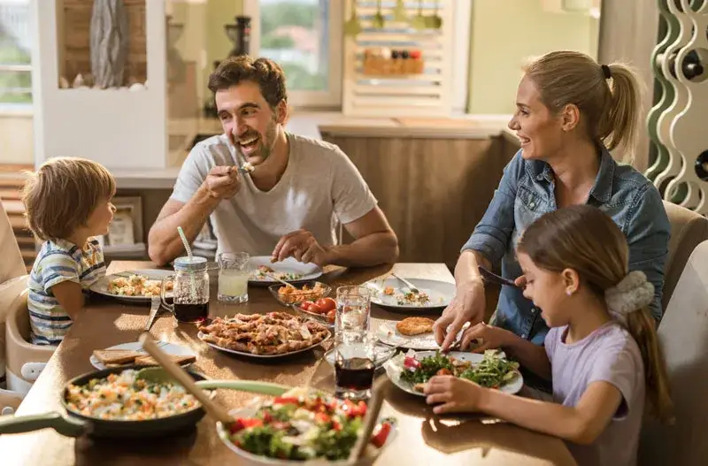 Familie isst gemeinsam ein gesundes Mittagessen
