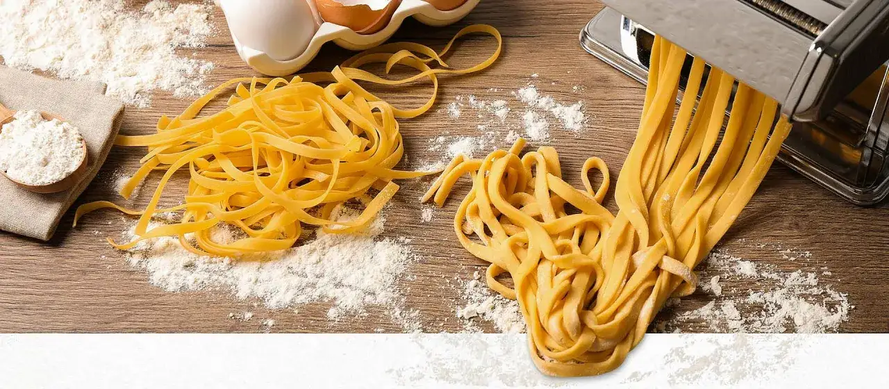 Frische selbstgemachte Pasta Teig und Nudeln auf Holztisch