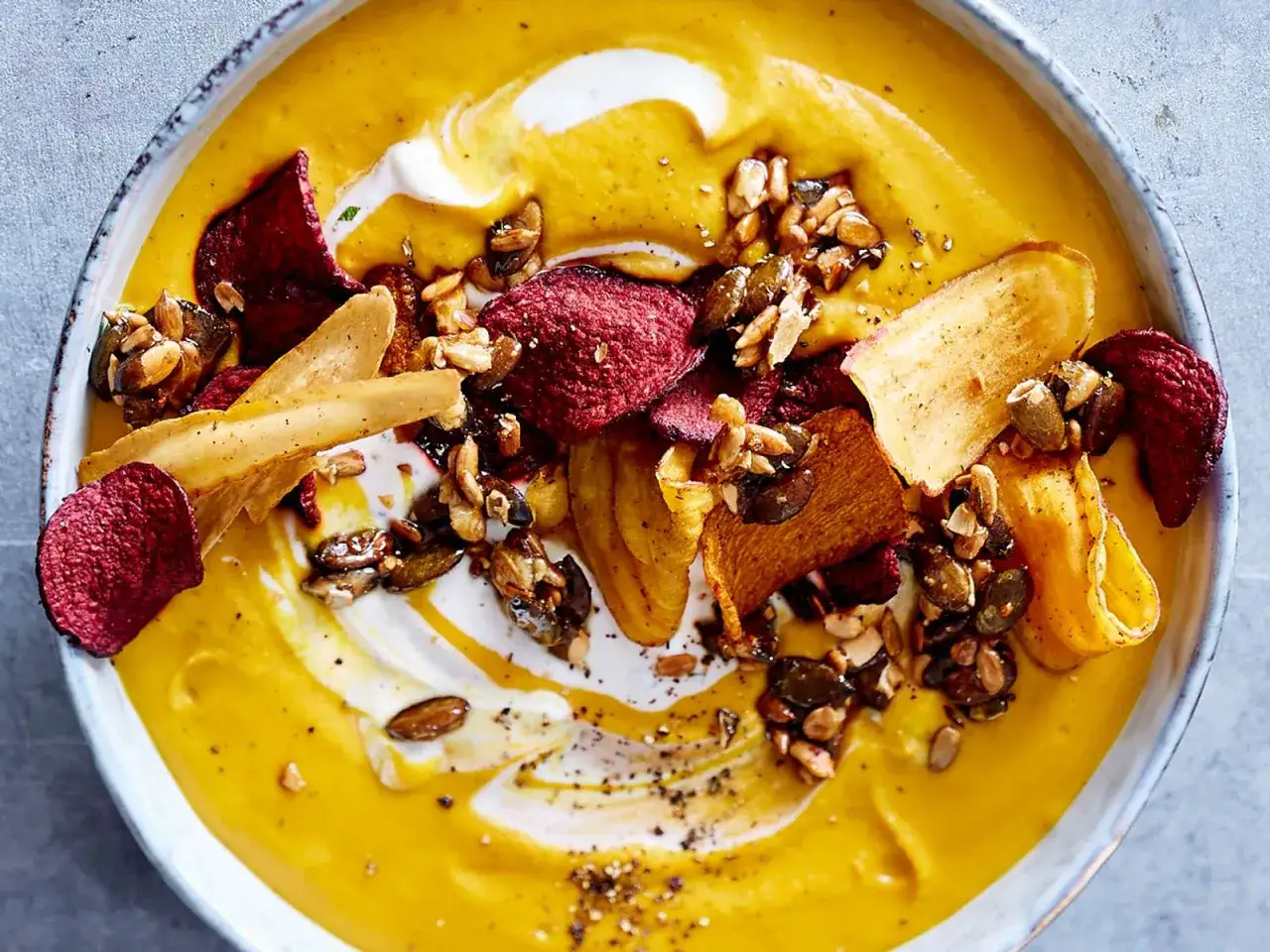verschiedene Toppings für Suppe wie Croutons Lachs und Kürbiskerne auf einem Tisch angerichtet